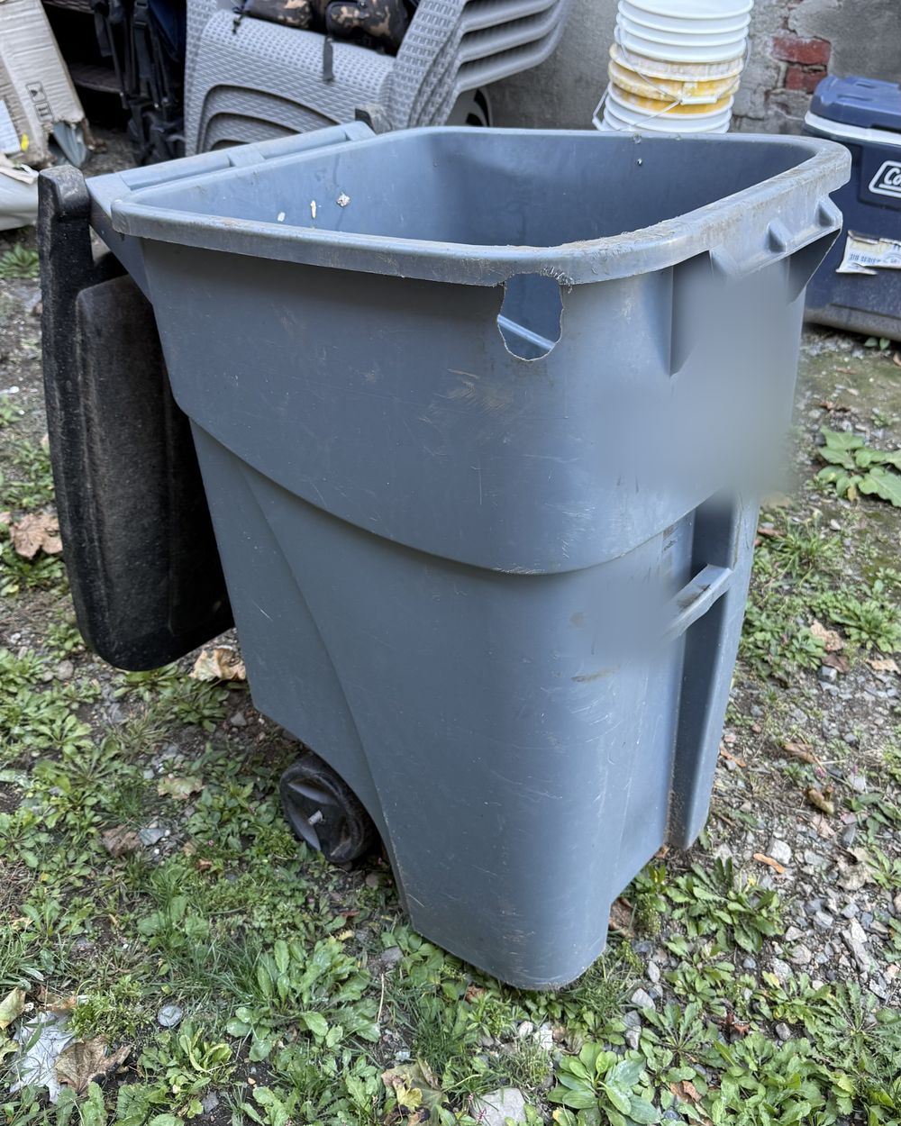 A dirty bin covered in grime and marker before cleaning.